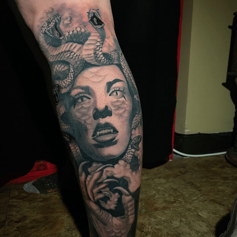 Black and grey tattoo face with snakes