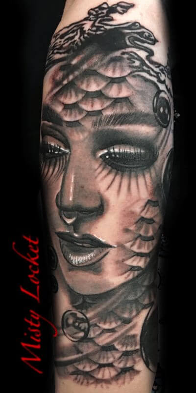 Black and grey tattoo of woman on arm