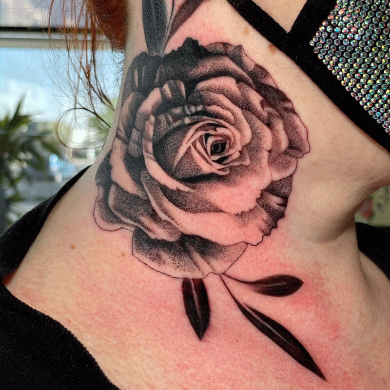 Black and great rose tattoo on neck
