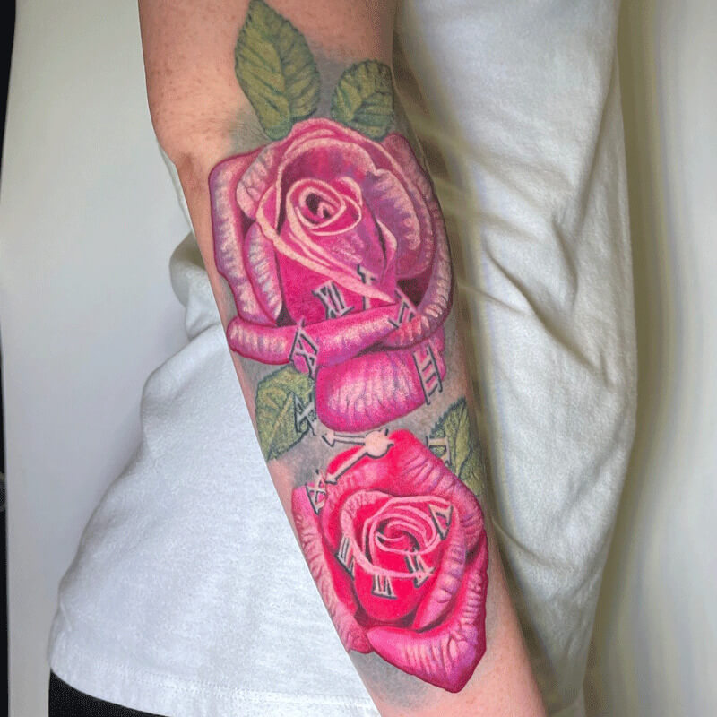 Color rose tattoo on arm