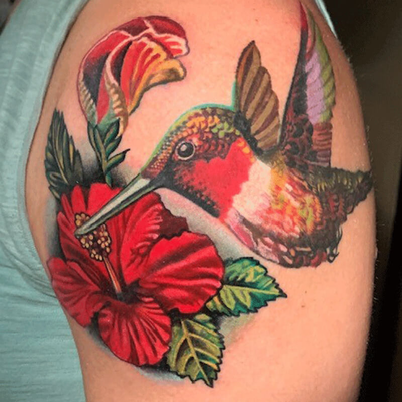 Color hummingbird with red flower tattoo