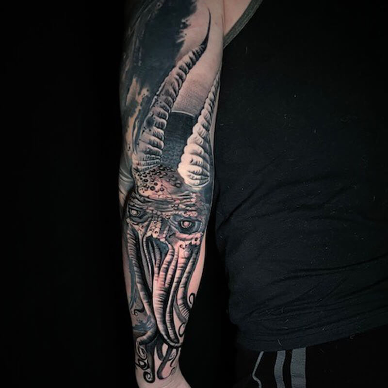 Kraken with horns tattoo on arm